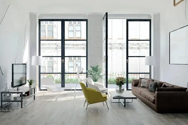 A living room with two large windows and a couch