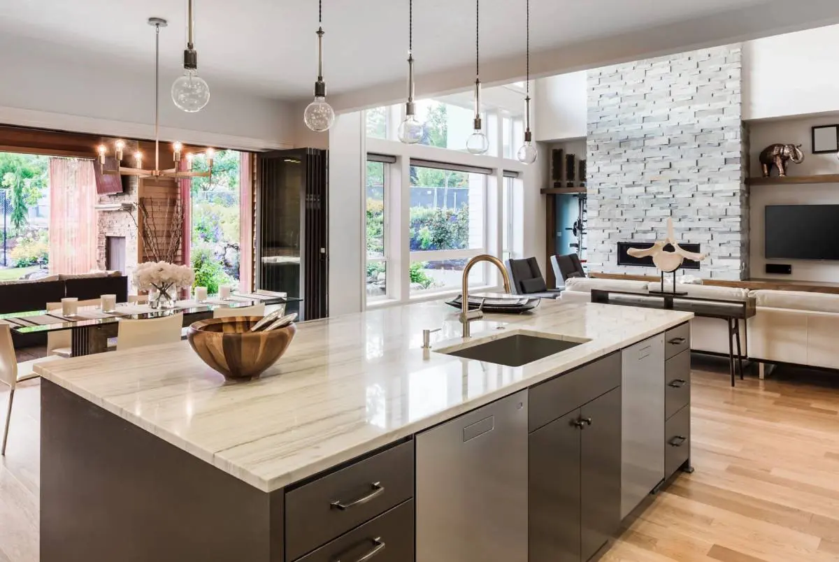 A kitchen with a large island and a sink.